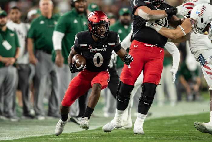 Nov 12, 2021; Tampa, Florida, USA; Cincinnati Bearcats running back Charles McClelland (0) runs the ball in the first quarter against the South Florida Bulls at Raymond James Stadium. Mandatory Credit: Jeremy Reper-USA TODAY Sports